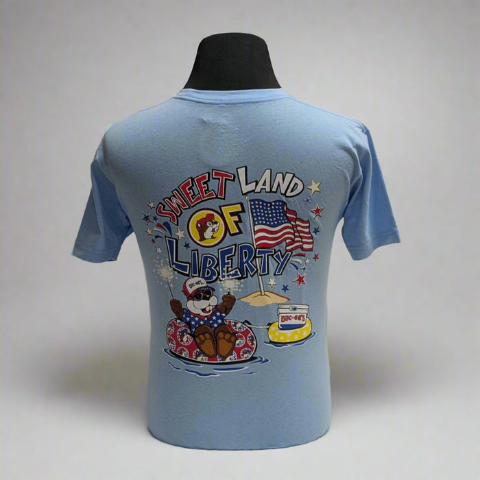 Buc-ee's 4th of July Shirt "Sweet Land of Liberty". Baby blue with logo on the front with the "Sweet land of Liberty" on the back with Buc-ee on a tube in the summer time.