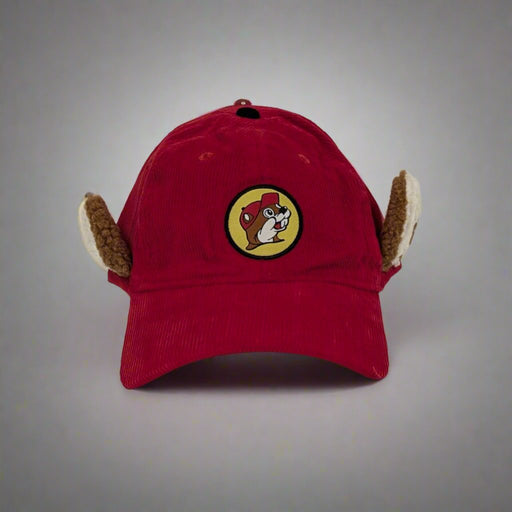 A red corduroy Buc-ee’s hat featuring plush ear flaps and the iconic Buc-ee’s logo embroidered on the front.
