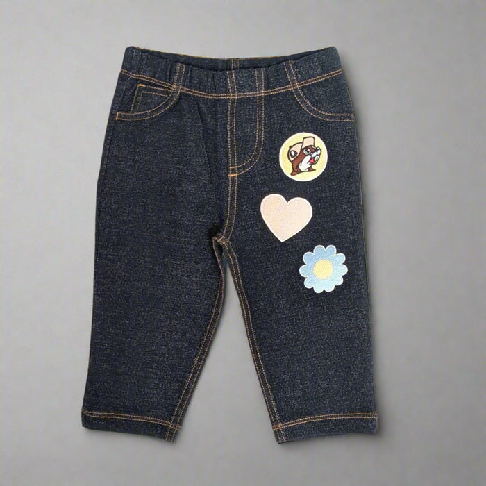 Buc-ee's Flower Heart Jeans for kids. Has a Buc-ee logo, heart, and flower on the front leg of the jeans.