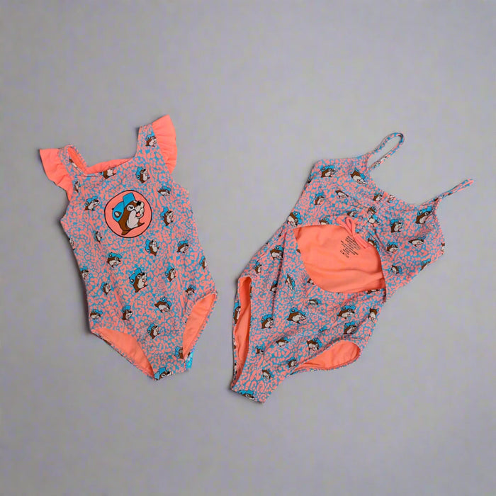 Buc-ee's Girls Pink and Blue Leopard Swim Suits. Youth has the stomach area showing and the toddler size is a one piece with a Buc-ee's logo.