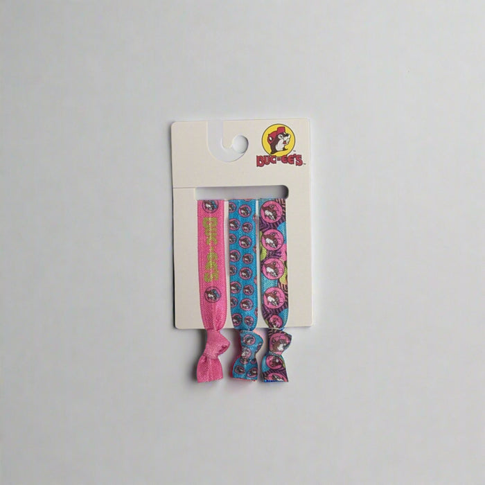Buc-ee's Hair Ties. 3 pack in pink, blue, and purple with Buc-ee's logos on it.