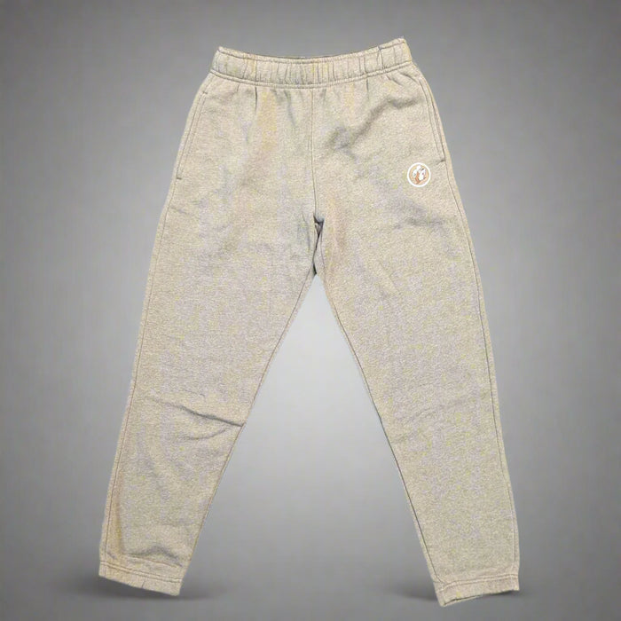 Flat lay of Buc-ee’s heather brown jogger pants with elastic waistband and ankle cuffs, featuring Buc-ee the Beaver patch on left leg