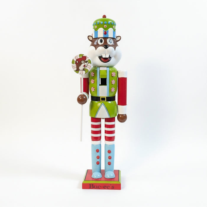 Buc-ee's Holiday Nutcracker - 2025 is holding a Lollipop and its a light green and blue with candies.