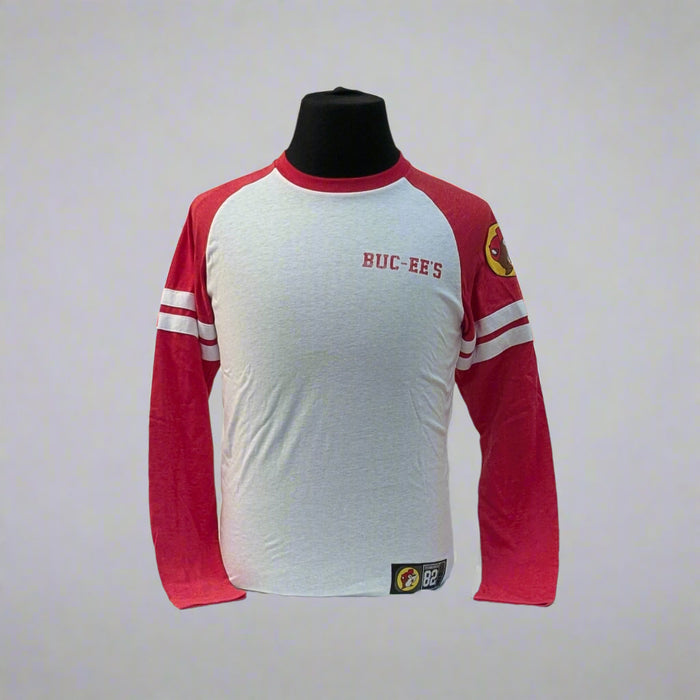 Buc-ee's Long Sleeve Raglan Shirt. Sleeves are red the body is white and it has the logo on the top left sleeve.