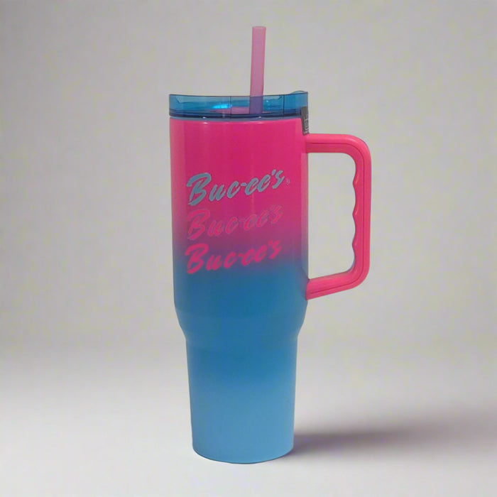Buc-ee's Pink/Blue Tumbler with Buc-ee's written on it 3 times and the ink is on the top blending in with the blue on the bottom.