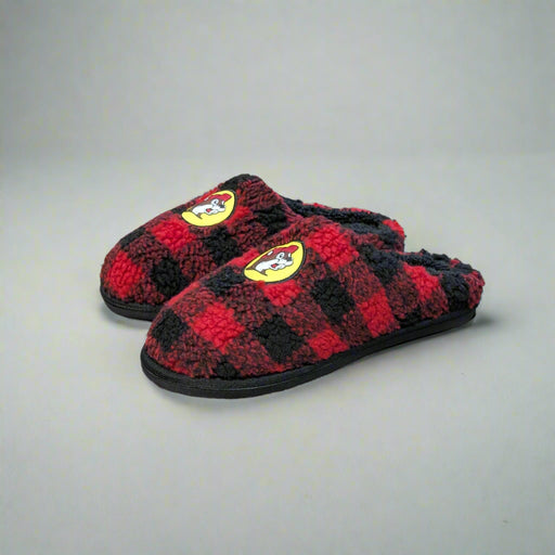 Pair of Buc-ee’s Plaid Sherpa Slippers featuring a red and black buffalo check pattern, soft sherpa lining, and Buc-ee’s beaver logo on the front.
