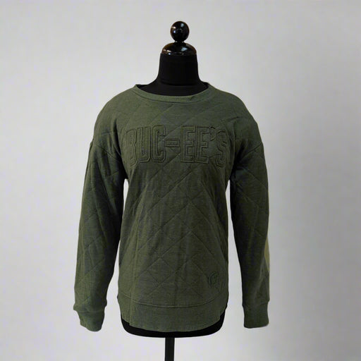 Green sweatshirt on a mannequin against a white backdrop with wooden paneling.