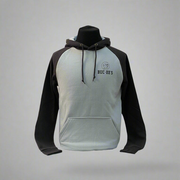 Buc-ee's Raglan Hoodie has a light gray body with black sleeves. It has a small Buc-ee's logo in the top left corner with the words Buc-ee's right under it.