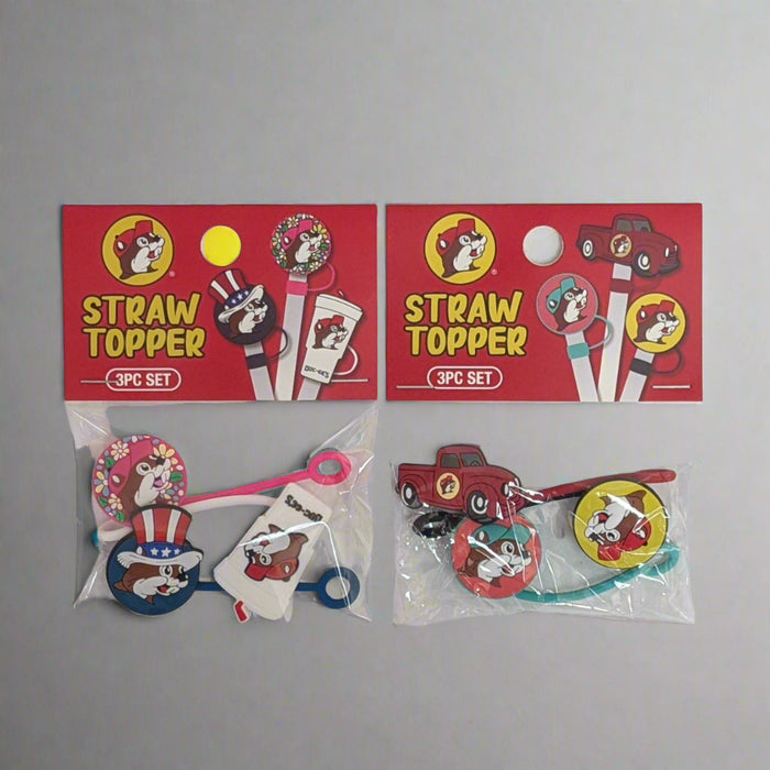Buc-ee's Straw Toppers. 2 Different 3 pack styles. One is a truck, Buc-ee's logo, pink Buc-ee's logo. The other is a Buc-ee's cup, 4th of July head, and Buc-ee with flowers.