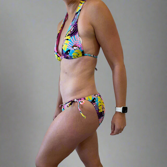 Buc-ee's Tropical Bikini has palm trees print all over in yellow, pink, and purple colors