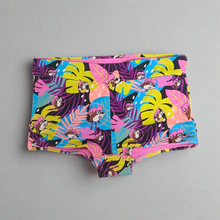 Buc-ee's Tropical Swim Bottoms lots of colorful palm leaves along with Buc-ee's logo.