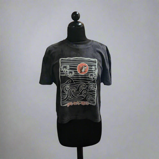 Buc-ee's Waves Crop Top. Black color with white waves and pink Buc-ee's logo.