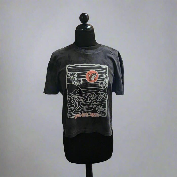 Buc-ee's Waves Crop Top. Black color with white waves and pink Buc-ee's logo.