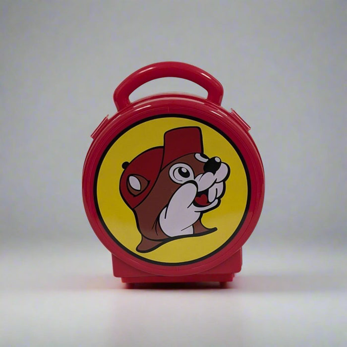 Red round Buc-ee's lunchbox with a handle, featuring the Buc-ee's beaver logo on a yellow background. Includes creative activities for kids inside.