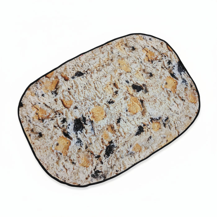 Back side of the H-E-B Creamy Creations “Cookies Over Texas” throw blanket featuring an all-over print resembling cookie and cream ice cream with cookie chunks.