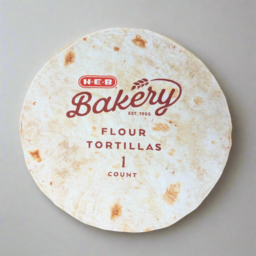 HEB Tortilla Blanket. Blanket in the shape of a tortilla and has Bakery and HEB on it.