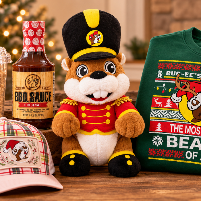 Buc-ee's Christmas gifts including a nutcracker plush, ugly sweater, pink plaid trucker hat, BBQ sauce, and cinnamon churro cookies.