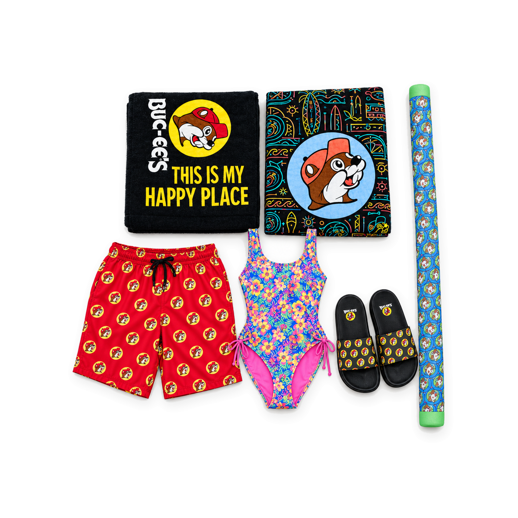 Buc-ee's beach and pool bundle with two beaver towels, red swim trunks, floral swimsuit, slides, and pool noodle