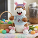 Plush Buc-ee toy with bunny ears on a wooden crate with Easter decorations