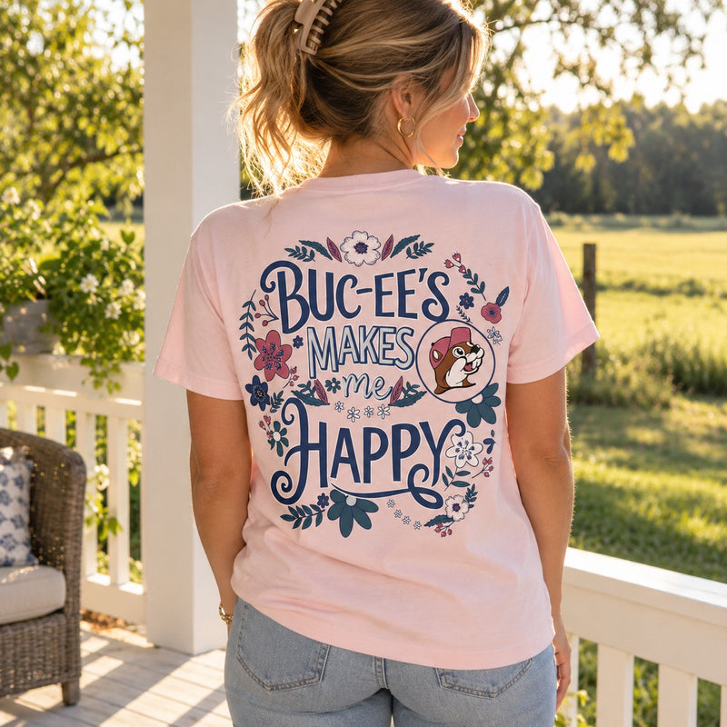 Woman on a porch showing the back of the pink Buc-ee's Makes Me Happy shirt