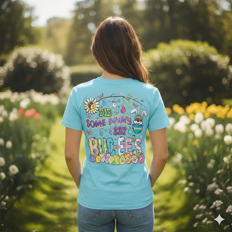 Person wearing a blue t-shirt with colorful Buc-ee's Easter shirt that says "Did some bunny say Buc-ee's" in a garden