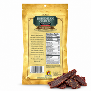 Back of the Bohemian Garlic Zero Sugar Beef Jerky bag with nutrition facts and jerky pieces