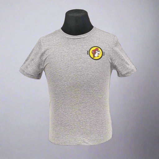 A gray t-shirt featuring a small Buc-ee's logo on the chest, displayed on a black mannequin.