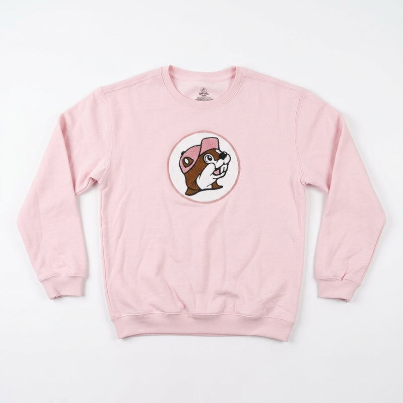 Light pink youth crewneck sweatshirt featuring a circular center patch of the Buc-ee's beaver wearing a pink hat in soft chenille fabric.