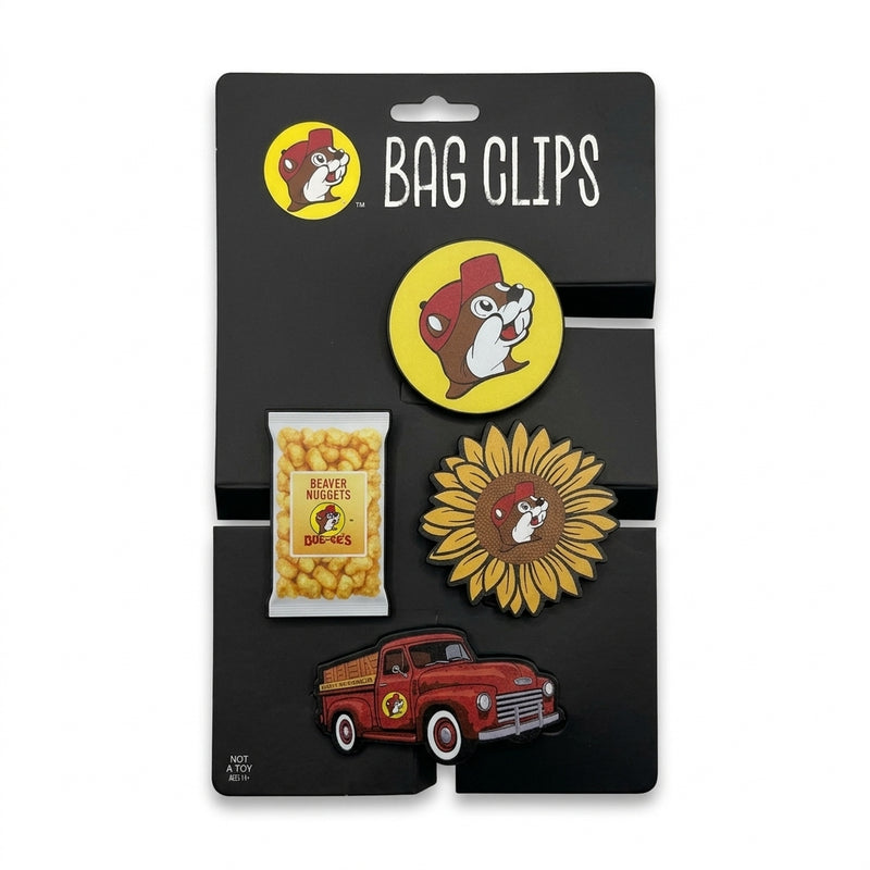 Four-piece Buc-ee’s novelty bag clip set featuring a round logo clip, a Beaver Nuggets bag clip, a sunflower clip, and a red truck clip on black packaging card.