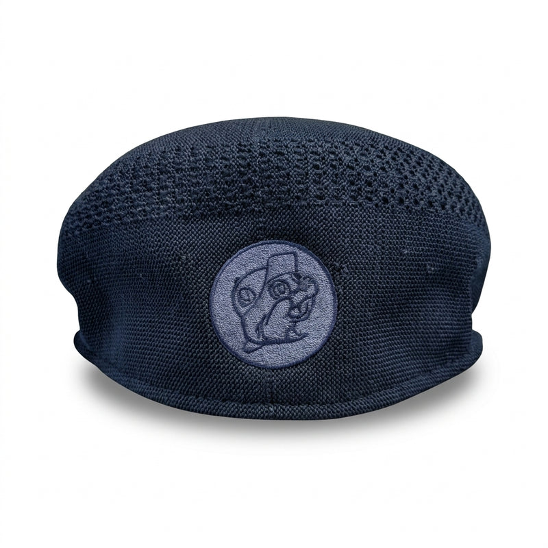 Back view of a navy blue textured knit flat cap displaying a round embroidered Buc-ee's beaver logo patch centered near the hem.