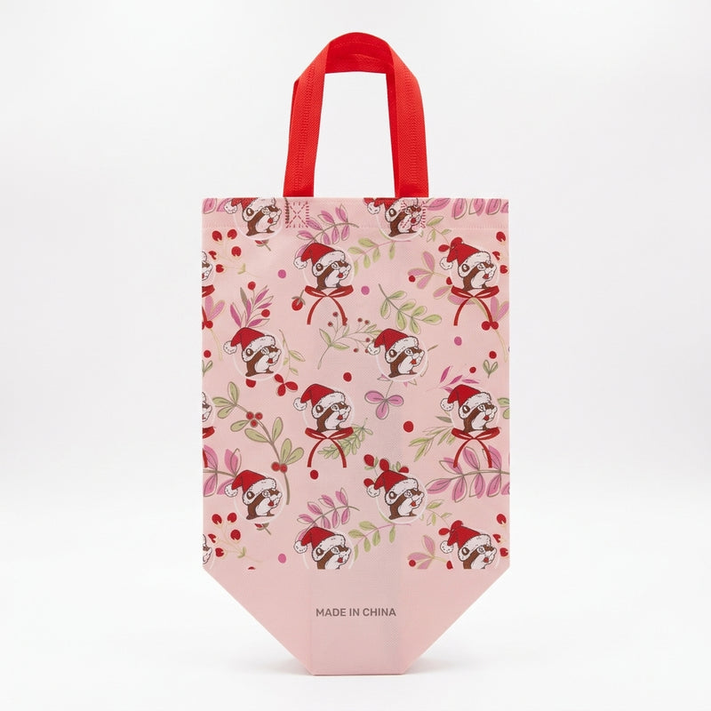 Light pink Buc-ee's tote bag displaying a repeating pattern of Santa Buc-ee surrounded by winter greenery, red berries, and bows.