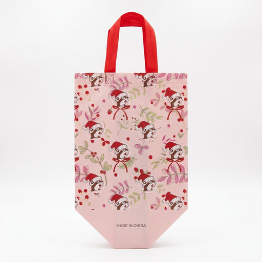 Light pink Buc-ee's tote bag displaying a repeating pattern of Santa Buc-ee surrounded by winter greenery, red berries, and bows.