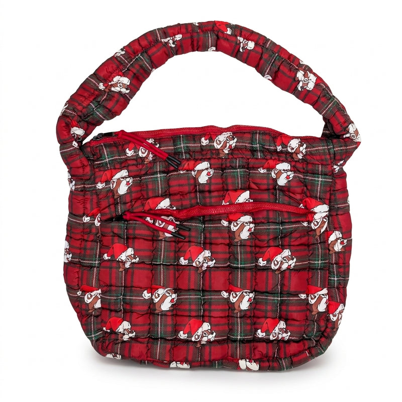 Flat lay of a quilted red and green plaid puffer tote bag featuring an all-over Santa Buc-ee print, padded shoulder strap, and an exterior zippered front pocket.