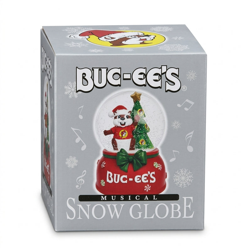 Buc-ee's Musical Snow Globe packaging displaying a glass globe with Buc-ee the Beaver wearing a Santa hat next to a Christmas tree on a red peppermint-adorned base.