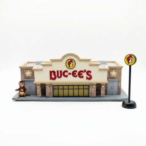Buc-ee's miniature store model front with red BUC-EE'S letters, Buc-ee the Beaver statue and round pole sign