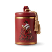 Front view of the Buc-ee's Holiday Spiced Cider red ceramic candle jar with lid and gold tassel, displaying a central holiday tree design with Buc-ee in a Santa hat.