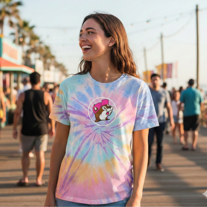 Woman wearing a tie-dye t-shirt with a logo on a boardwalk