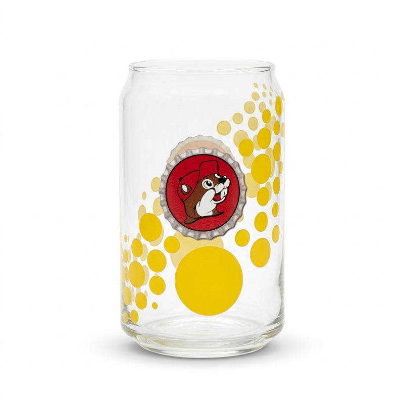 A clear 12oz can-shaped drinking glass featuring a central graphic of a red bottle cap with the Buc-ee's beaver mascot, surrounded by a bright yellow polka dot pattern.