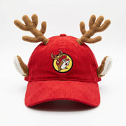 Front view of a red corduroy Buc-ee’s baseball cap with plush brown reindeer antlers and ears, featuring an embroidered circular patch of Buc-ee wearing reindeer antlers.