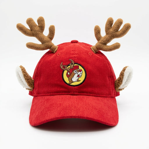 Front view of a red corduroy Buc-ee’s baseball cap with plush brown reindeer antlers and ears, featuring an embroidered circular patch of Buc-ee wearing reindeer antlers.