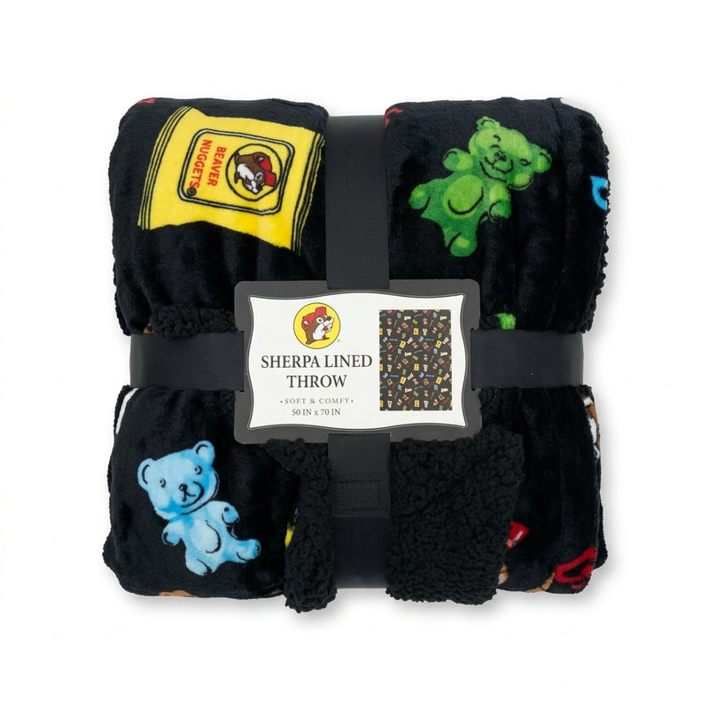 Black Buc-ee's sherpa-lined throw blanket wrapped with product label showing a pattern of Buc-ee's snacks and beaver logos.