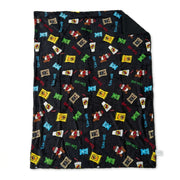 Black Buc-ee's sherpa-lined throw blanket laid flat, featuring a colorful print of Beaver Nuggets, drinks, gummy bears, beef jerky, and Buc-ee's logos.