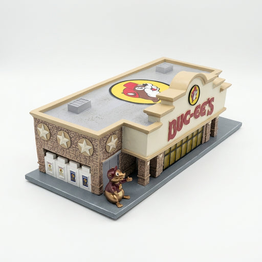 Angled view of the Buc-ee's miniature store with a roof logo, star stonework, ice chests and Buc-ee the Beaver statue