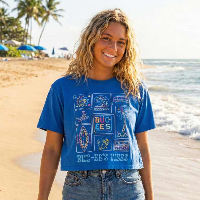 Woman wearing a blue graphic t-shirt on a beach