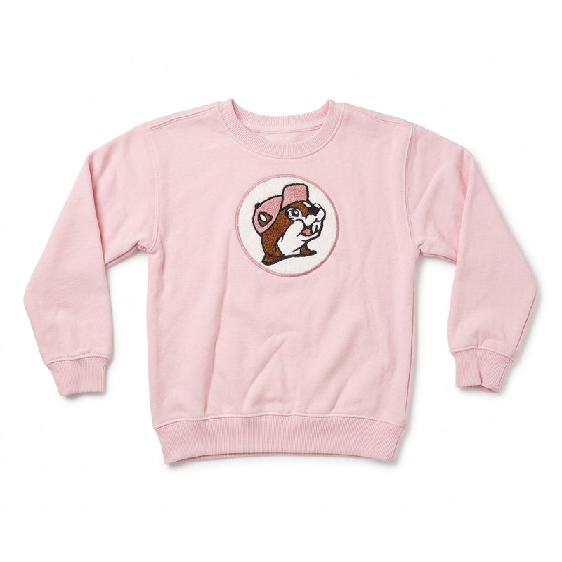 Light pink youth crewneck sweatshirt featuring a circular center patch of the Buc-ee's beaver wearing a pink hat in soft chenille fabric.