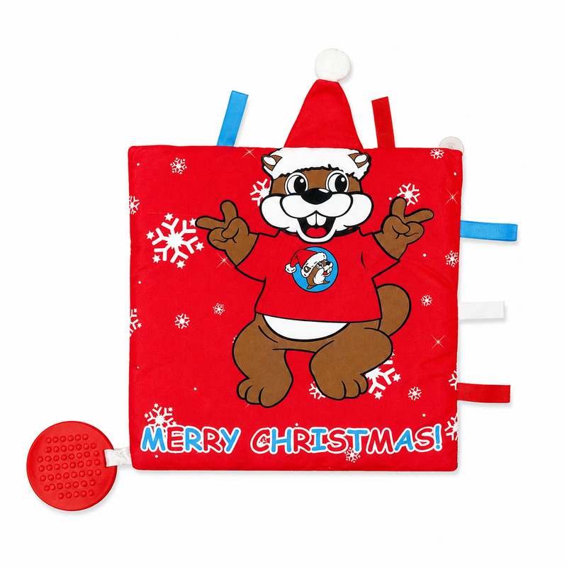Buc-ee’s Christmas baby blanket featuring a red background with a festive beaver wearing a Santa hat, white snowflakes, colorful sensory ribbons, and “Merry Christmas!” lettering.