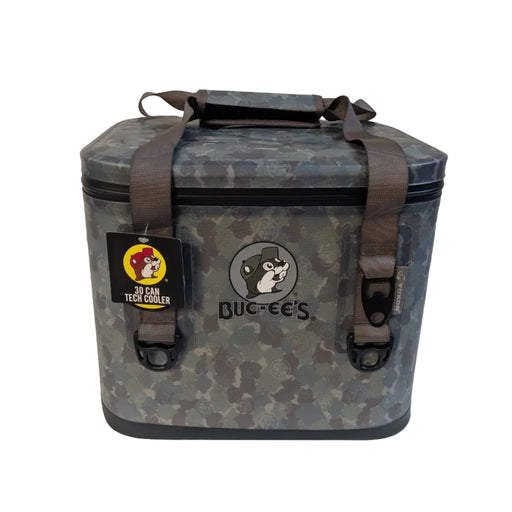A front-facing product photograph of the Buc-ee's 30 Can Tech Cooler in a green and grey digital camouflage pattern, sitting on a white surface. The heavy-duty soft cooler features a large grey Buc-ee's beaver logo printed on the front, durable grey nylon carrying straps with black plastic loops, and a black retail hangtag on the left strap that reads "30 Can Tech Cooler" with the classic yellow Buc-ee's logo.