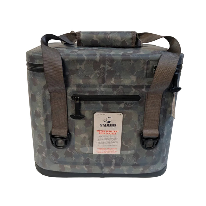 A product photograph displaying the back side of the digital camo Buc-ee's Tech Cooler. Centered on the back is a clear, integrated plastic window displaying a retail insert that reads "YUKON OUTFITTERS WATER RESISTANT TECH POCKET." Directly above the clear window is a horizontal black water-resistant zipper with a heavy-duty T-bar pull tab.