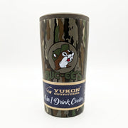 A camouflage pattern stainless steel 4-in-1 drink cooler by Yukon Outfitters sitting on a black wire rack. The tumbler features a bark camo design, a circular logo of the Buc-ee's beaver wearing a green camo cap above bold "BUC-EE'S" text, and a blue package band reading "Yukon Outfitters 4 in 1 Drink Cooler".