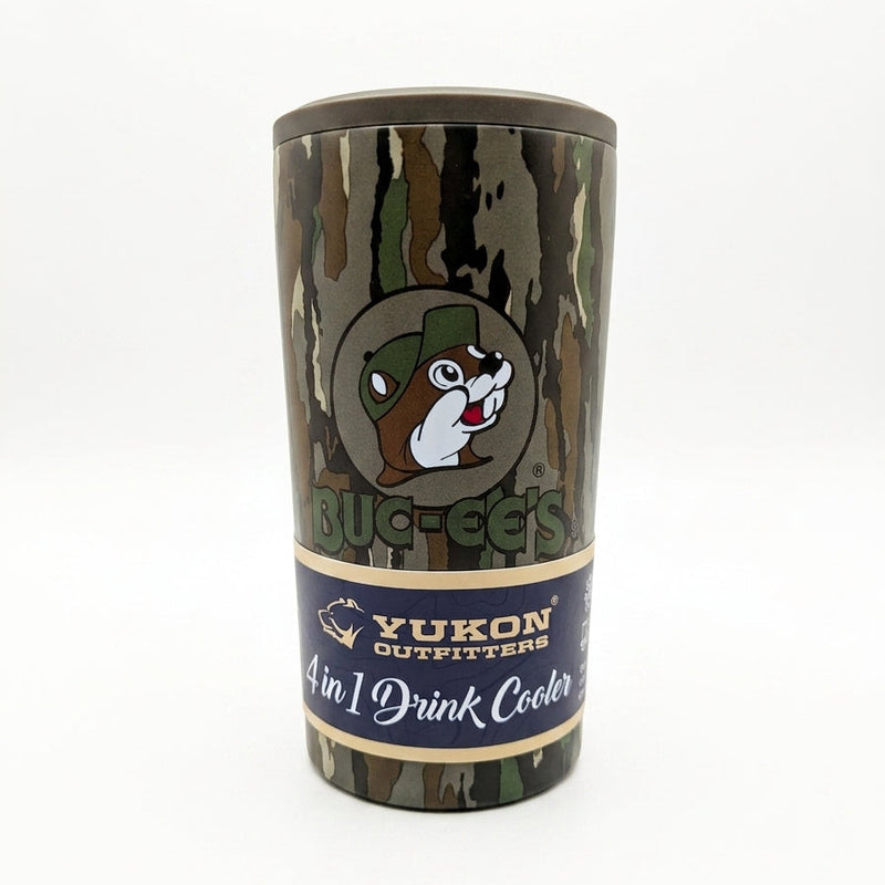 A camouflage pattern stainless steel 4-in-1 drink cooler by Yukon Outfitters sitting on a black wire rack. The tumbler features a bark camo design, a circular logo of the Buc-ee's beaver wearing a green camo cap above bold "BUC-EE'S" text, and a blue package band reading "Yukon Outfitters 4 in 1 Drink Cooler".